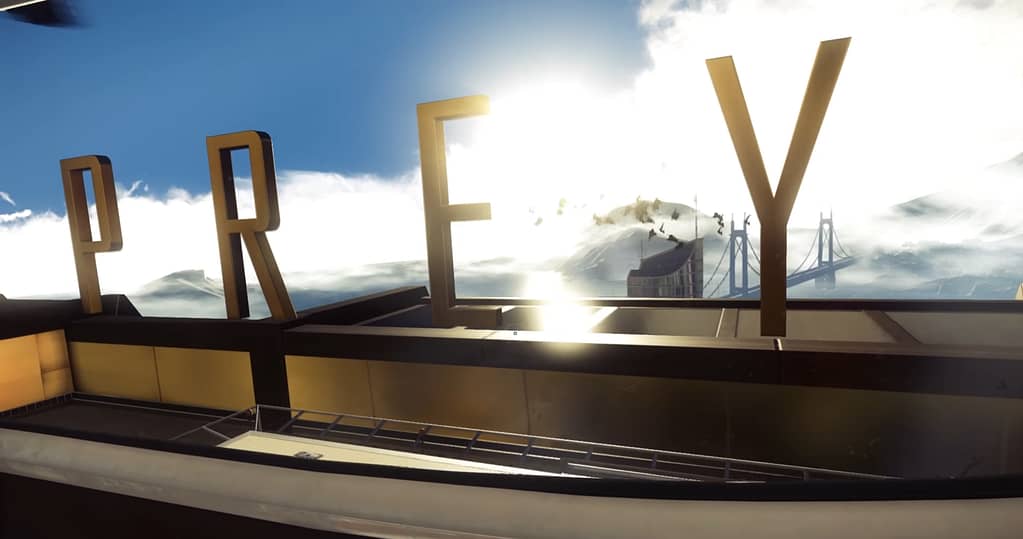 Image descriptor: A screenshot from the opening to Prey. From a rooftop overlooking a horizon, with a large bridge seen in the background. Large bold letters spell out the title of the game, integrated naturally into the environment.