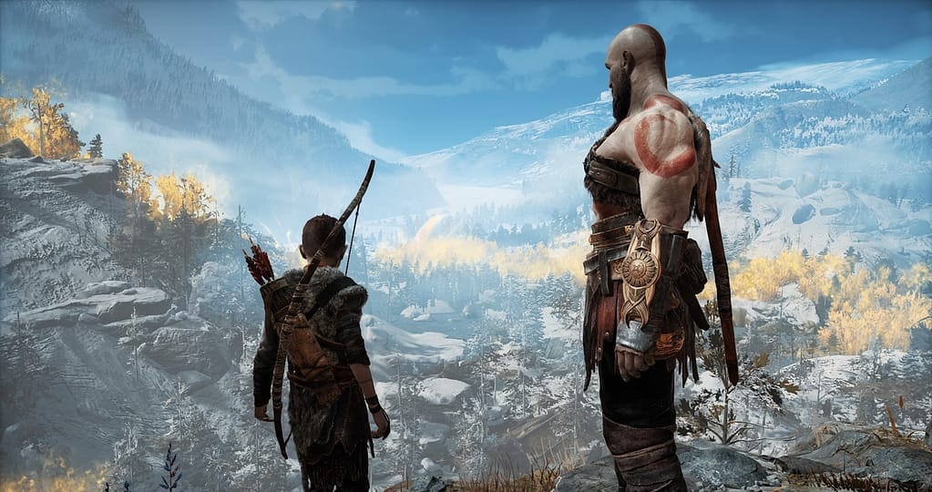 Image Descriptor: A screenshot from God of War 2018, featuring Atreus and Kratos looking over a vast and snowy forest, circled by golden trees.