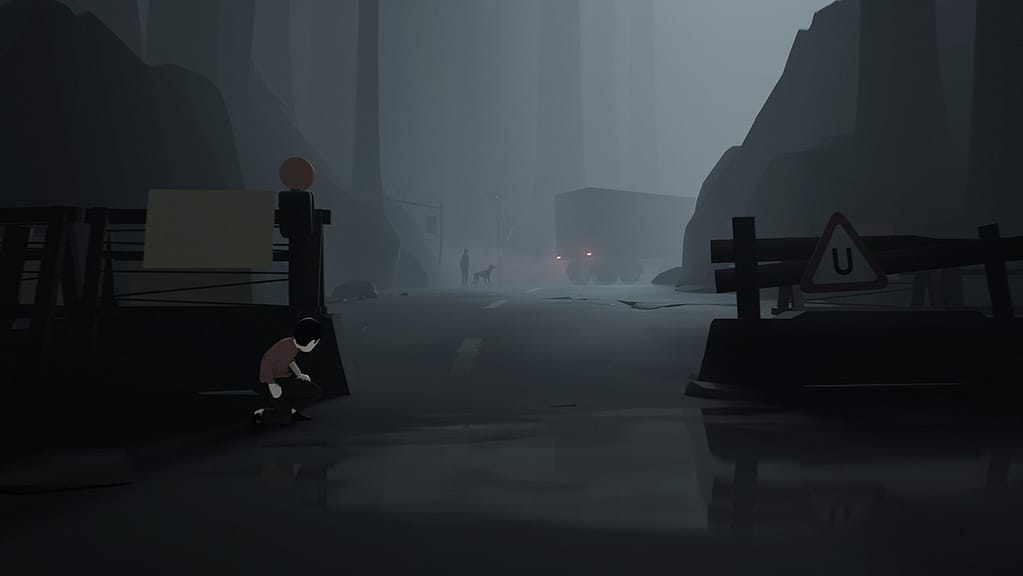 Image descriptor: A young boy hides behind a roadblock, peering around to see a dog, a man and a truck in the foggy distance.