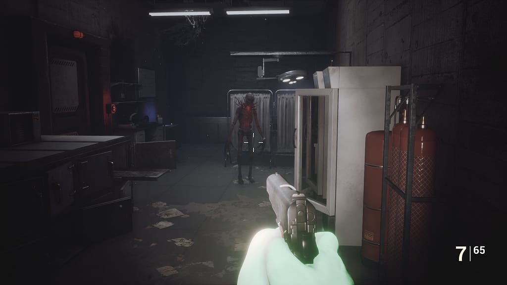 Image descriptor: From a first person perspective, Roberto aims a handgun at a spiky monster with a glowing red external heart. This takes place within a makeshift medical room.