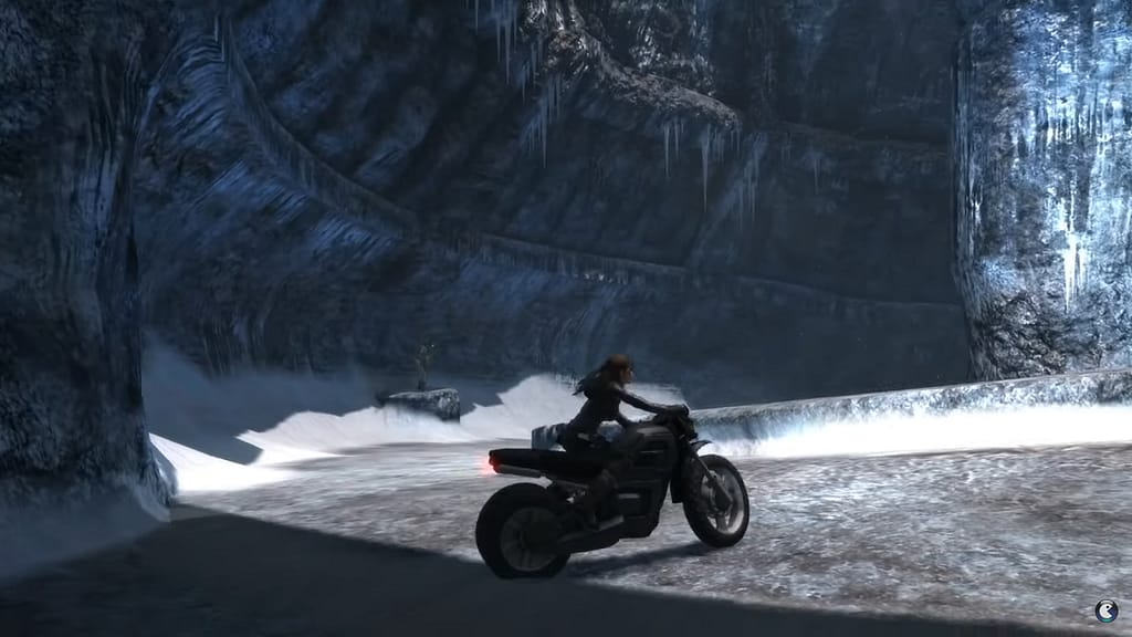 Image Descriptor: Lara sits stationary on her motorcycle, within a curving Norse ruin that has frozen somewhat. Snow can still be seen at either side of the path ahead.