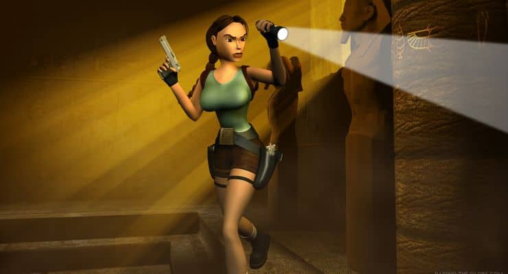 Image Descriptor: A poster for Tomb Raider 4. Lara Croft cautiously rounds a corner in a dreary Egyptian tomb. She aims a flashlight off-screen with one hand, whilst readying a handgun with her other.