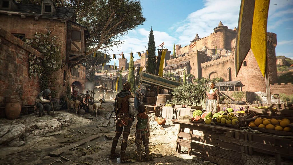 Image Descriptor: Amicia and Hugo stand on a well worn dirt path, against a colourful background made up of castles, decorations and greenery. A woman stands nearby running a fresh vegetable stall.