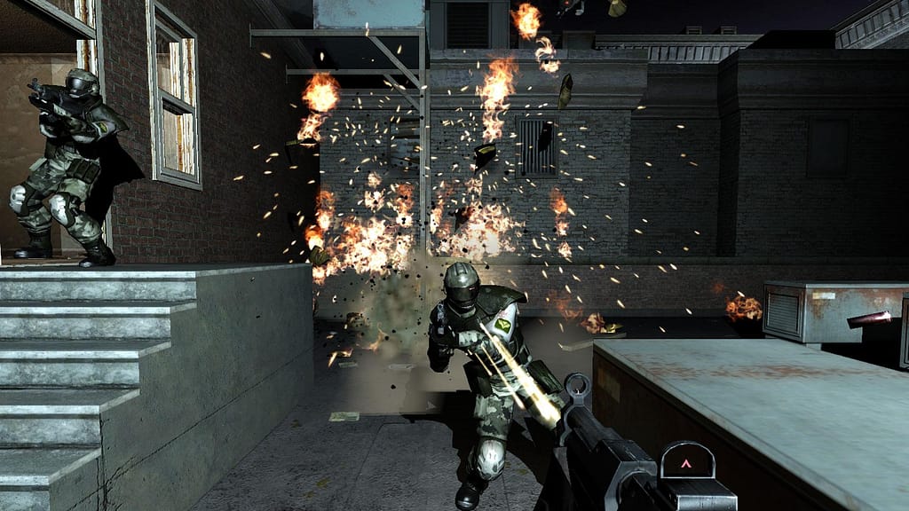 Image descriptor: From a first person perspective, the protagonist shoots a submachine gun at a guard whilst an explosion occurs in the background. Another soldiers leans around the corner at the top of some stairs to the left.