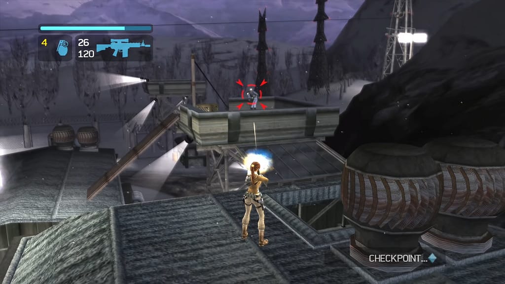 Image Descriptor: Atop a roof in a snowed over military base in Kazakhstan, Lara shoots an assault rifle at a soldier, who is highlighted with a red crosshair. A small HUD can be seen in the top left showing Lara's health, ammo, and number of grenades, whilst a small box in the bottom right notifies that the game has hit a checkpoint.