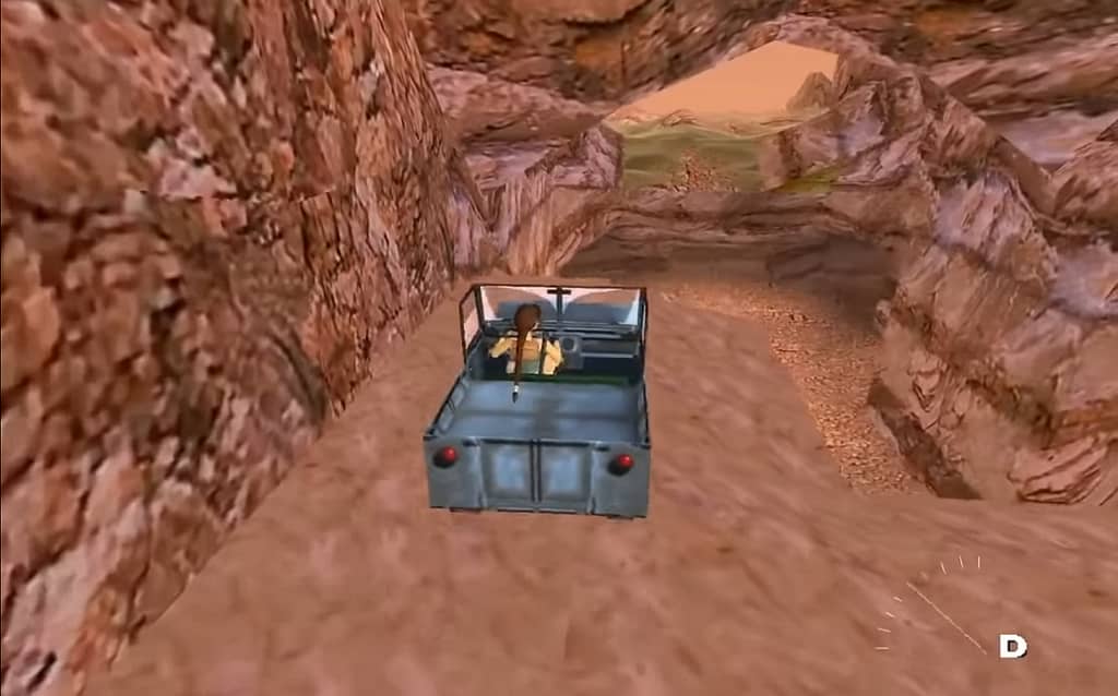 Image Descriptor: In an extremely rocky environment —coated in about 30 different shades of the colour brown— Lara Croft sits in the drivers seat of a large jeep, ready to brave the terrain.