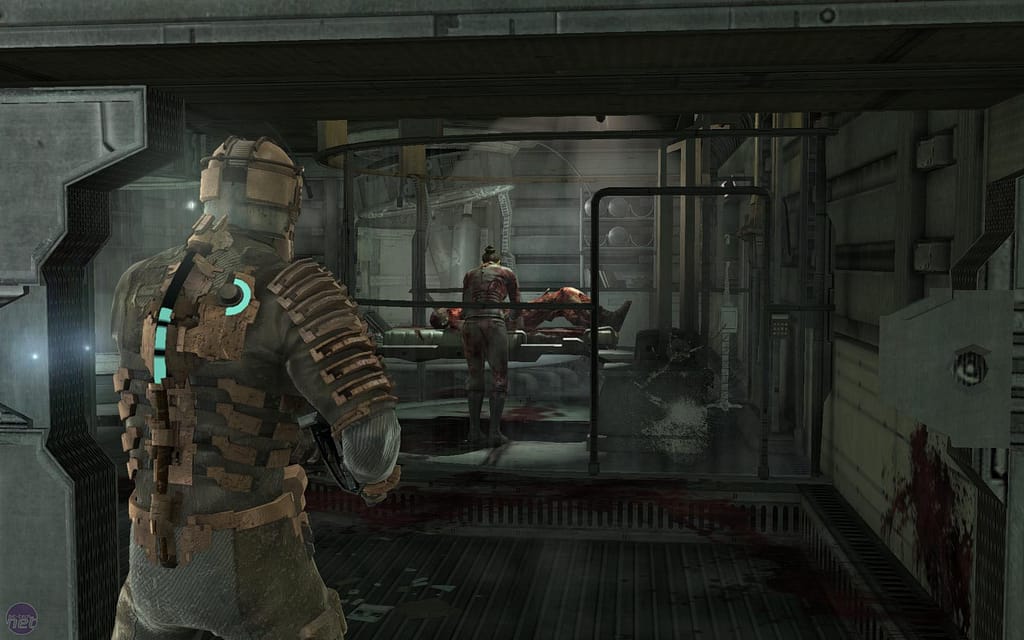 Image descriptor: Isaac Clark, wearing a bulky engineering suit, stands before an injured woman, who is hunched over a bloodied man.